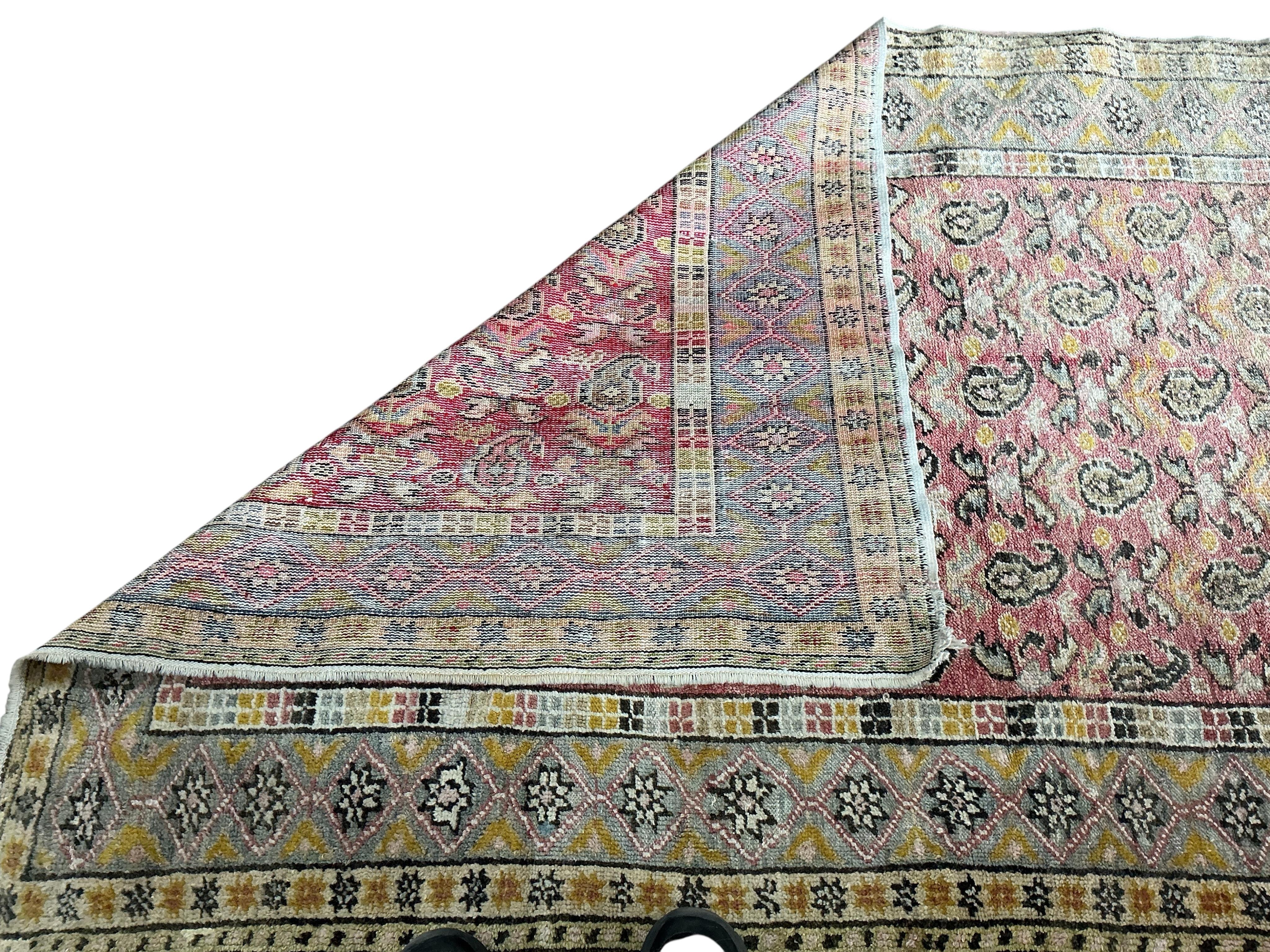 A Turkish pale red ground boteh rug, 194 x 158cm